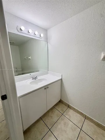 a bathroom with a sink and mirror
