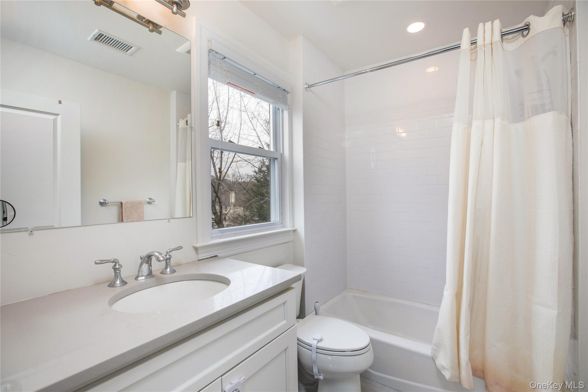 199 Purchase Street, Unit 2 Rye, NY 10580 - Photo 11 of 14 a bathroom with a granite countertop sink toilet and shower