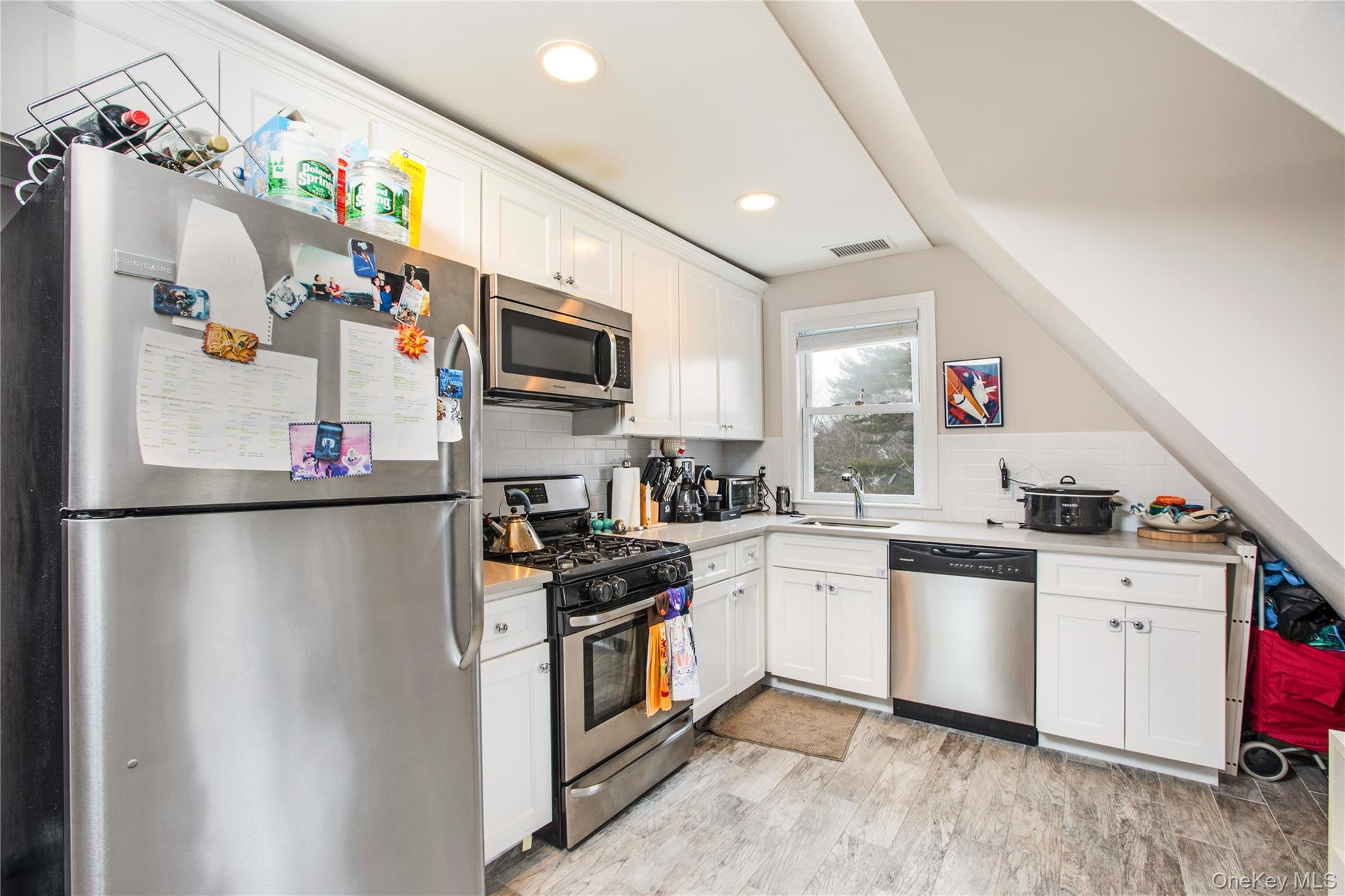 199 Purchase Street, Unit 2 Rye, NY 10580 - Photo 7 of 14 a kitchen with granite countertop a sink stove and refrigerator