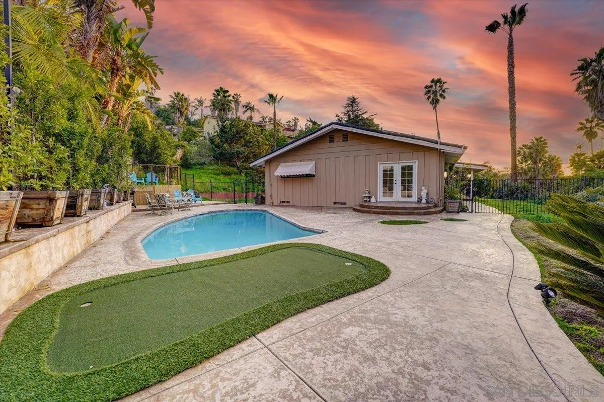 a view of a house with a yard patio and fire pit
