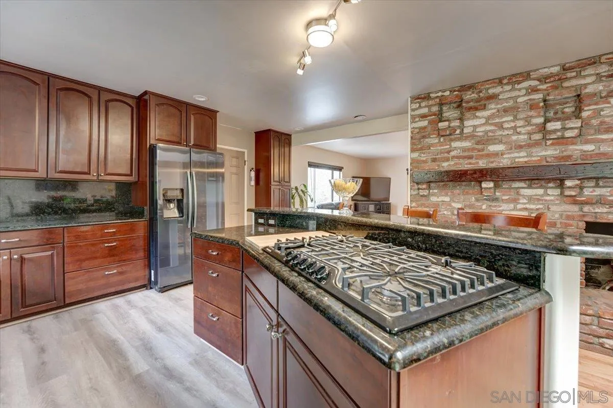 4561 Conrad Drive La Mesa, CA 91941 - Photo 12 of 59 a kitchen with stainless steel appliances granite countertop a stove a sink and a refrigerator