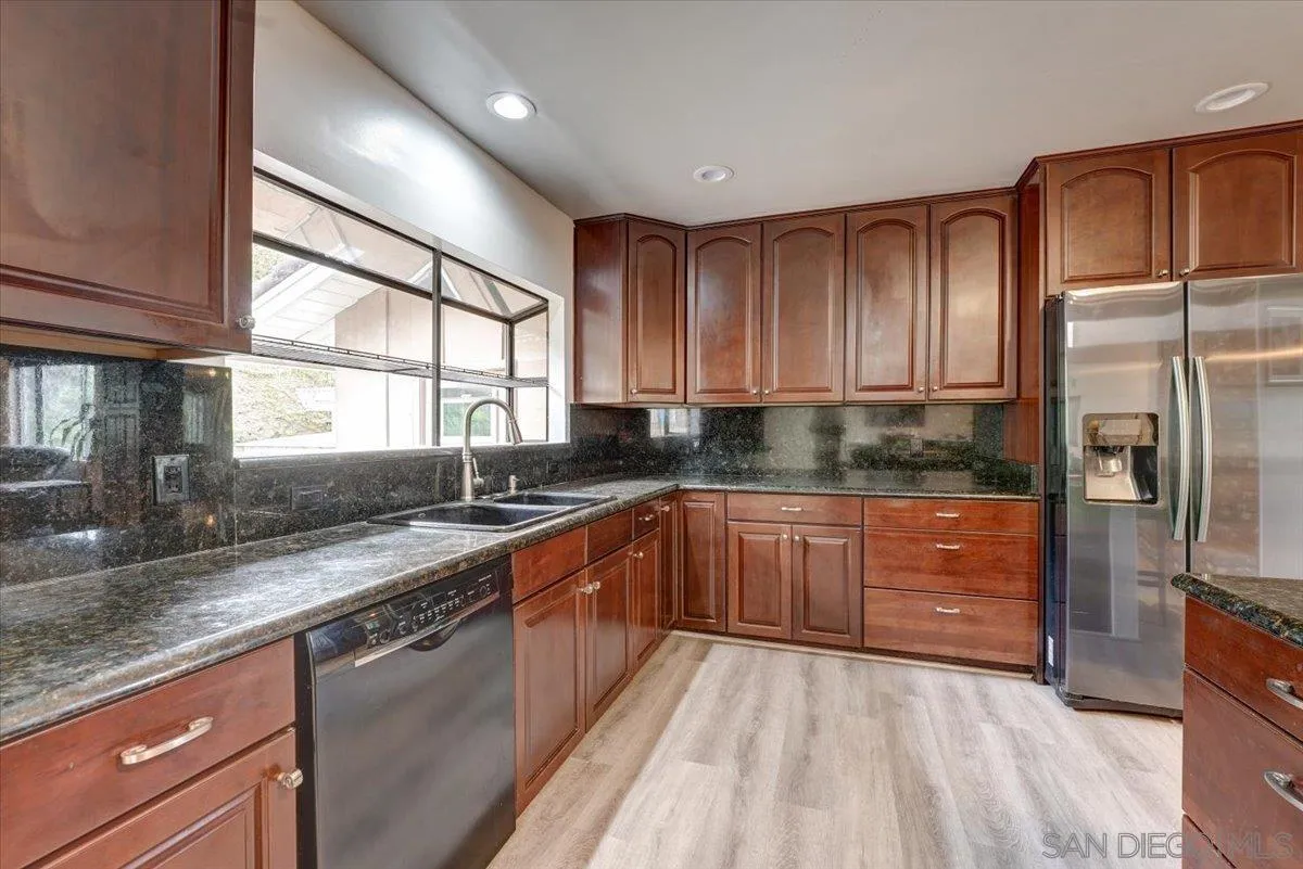 4561 Conrad Drive La Mesa, CA 91941 - Photo 13 of 59 a kitchen with granite countertop stainless steel appliances a refrigerator sink and microwave