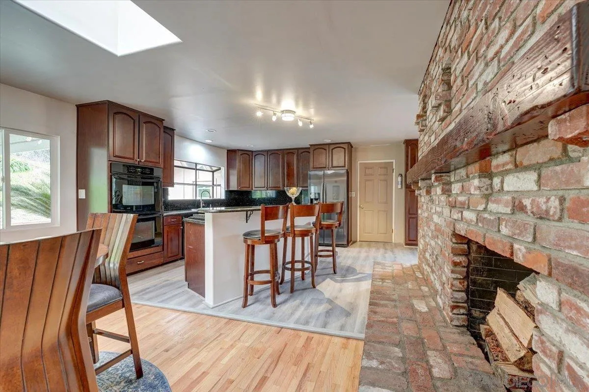 4561 Conrad Drive La Mesa, CA 91941 - Photo 15 of 59 a dining room with furniture and a fireplace
