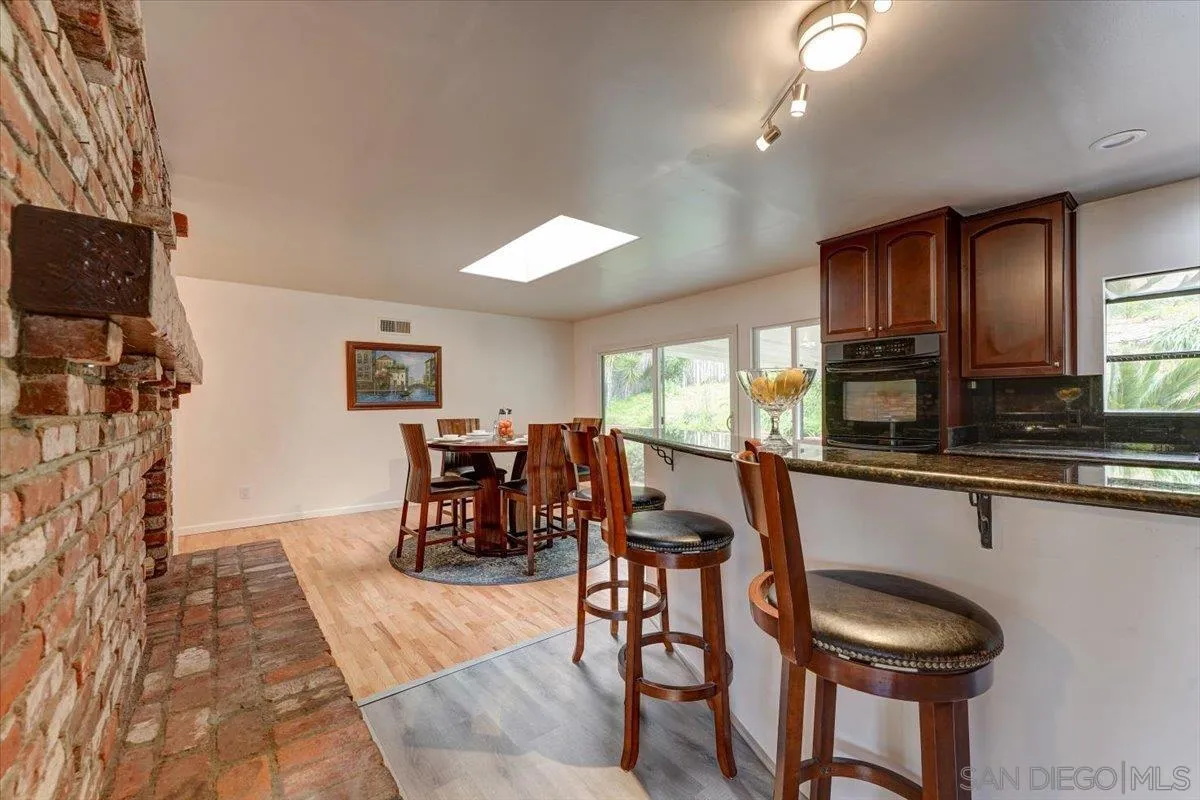 4561 Conrad Drive La Mesa, CA 91941 - Photo 18 of 59 a kitchen with stainless steel appliances granite countertop a table and chairs in it