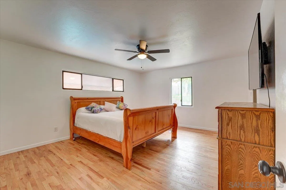 4561 Conrad Drive La Mesa, CA 91941 - Photo 20 of 59 a bedroom with a bed and a flat screen tv