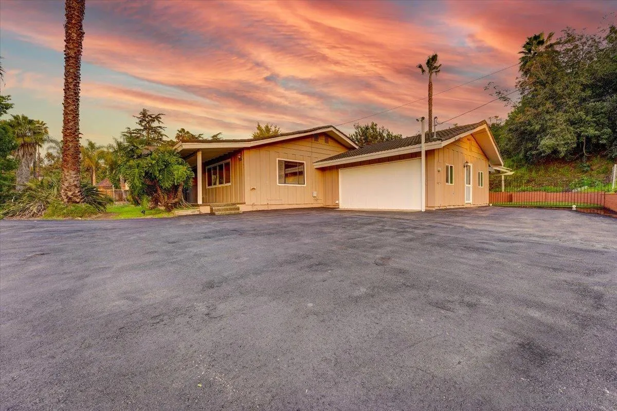 4561 Conrad Drive La Mesa, CA 91941 - Photo 2 of 59 a front view of a house with a garden and yard