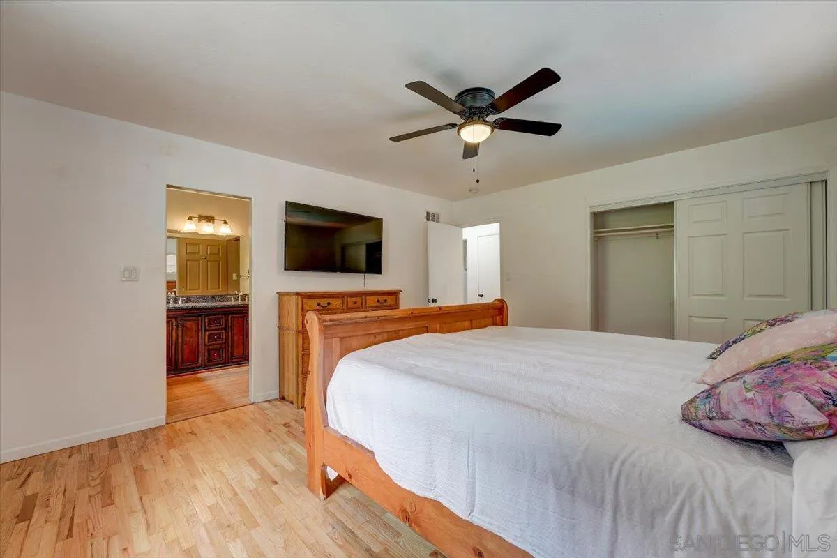 4561 Conrad Drive La Mesa, CA 91941 - Photo 21 of 59 a bedroom with a bed and a flat screen tv