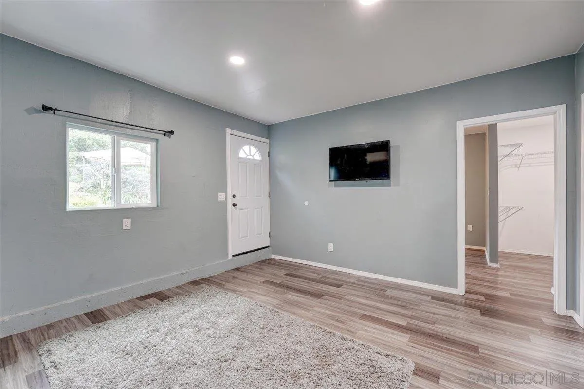 4561 Conrad Drive La Mesa, CA 91941 - Photo 33 of 59 a view of an empty room with wooden floor and a window
