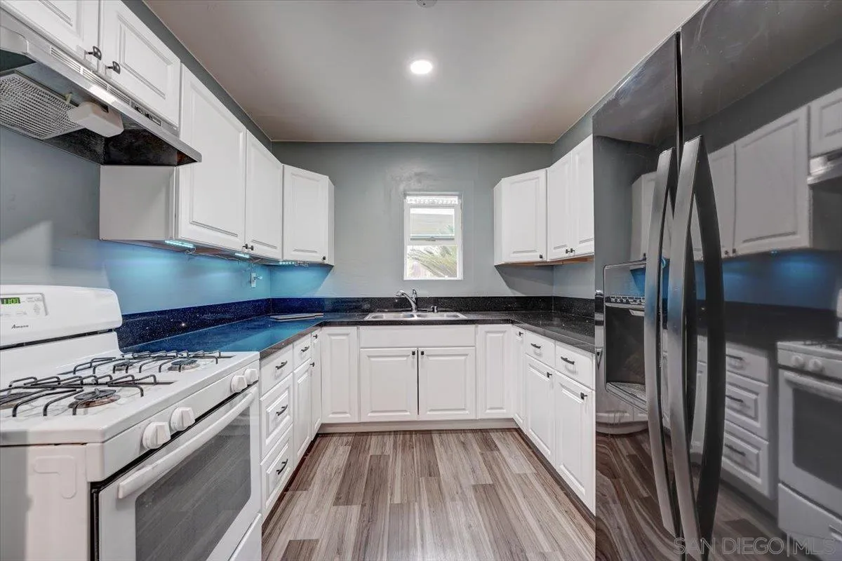 4561 Conrad Drive La Mesa, CA 91941 - Photo 36 of 59 a kitchen with a stove a sink and a refrigerator
