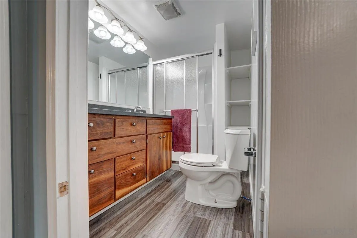 4561 Conrad Drive La Mesa, CA 91941 - Photo 40 of 59 a bathroom with a toilet shower vanity and a sink