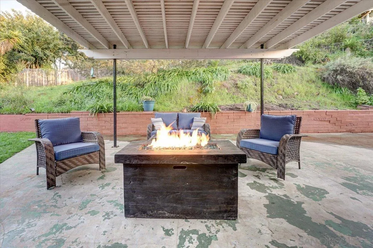 4561 Conrad Drive La Mesa, CA 91941 - Photo 50 of 59 a view of a patio with table and chairs potted plants with large tree