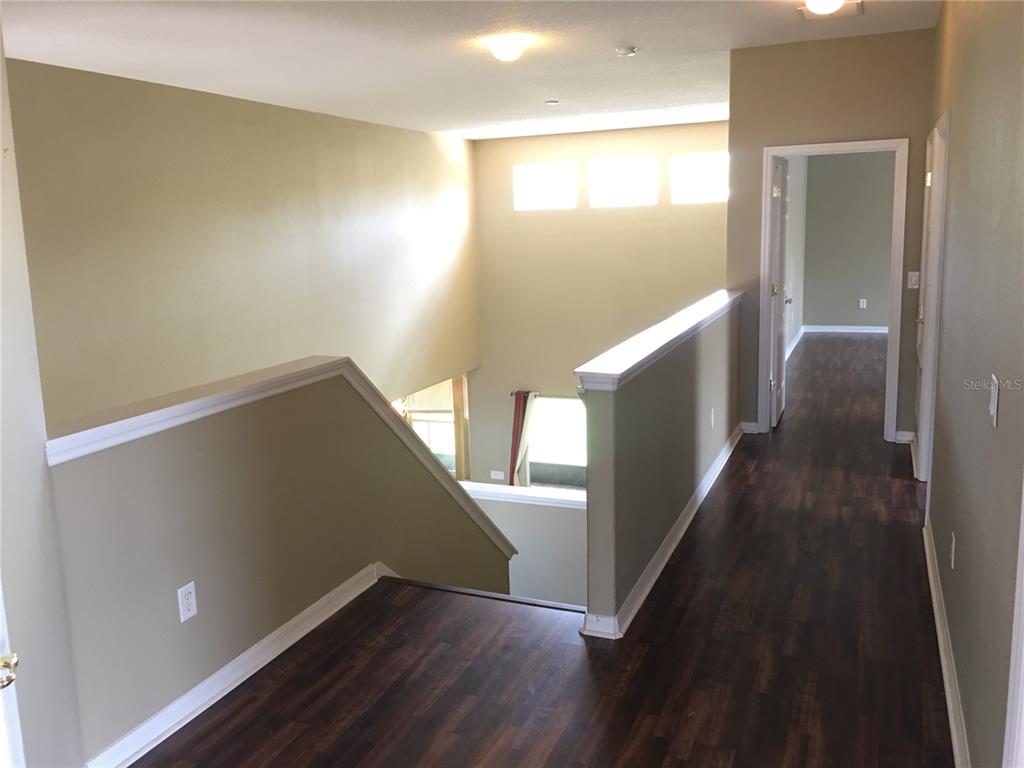 18047 Java Isle Drive Tampa, FL 33647 - Photo 15 of 21 a view of a hallway with wooden floor
