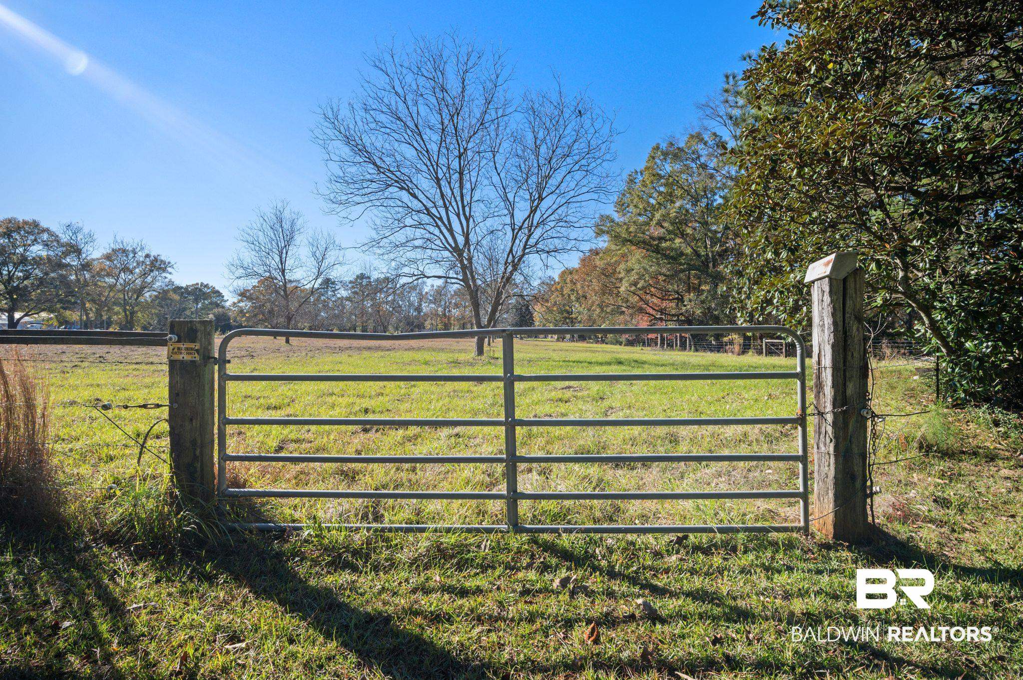 15801 Maytower Road Bay Minette, AL 36507 - Photo 39 of 43 View of gate featuring a lawn and a rural view
