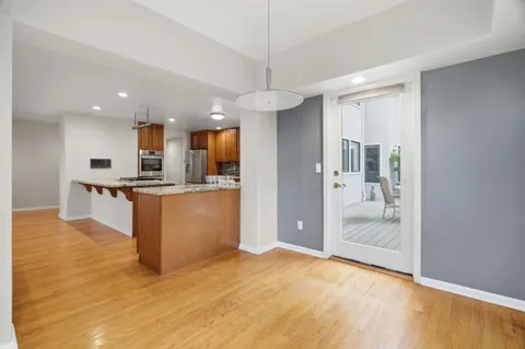 a large kitchen with stainless steel appliances granite countertop a stove and a sink