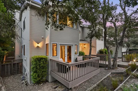 a view of a house with a yard and deck
