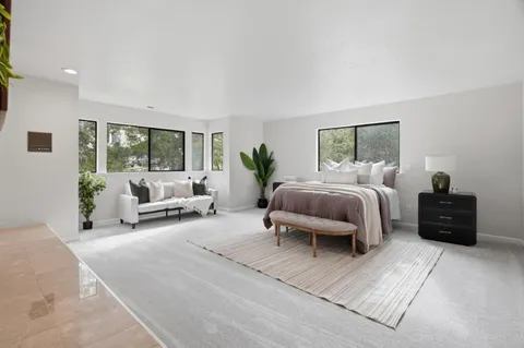 a spacious bedroom with a bed and a fireplace