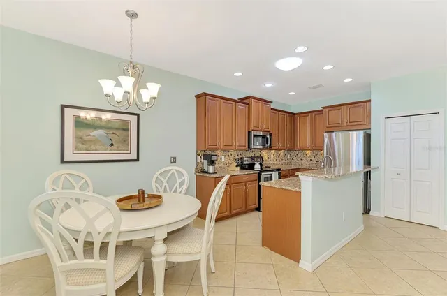 a kitchen with stainless steel appliances granite countertop a refrigerator sink and cabinets