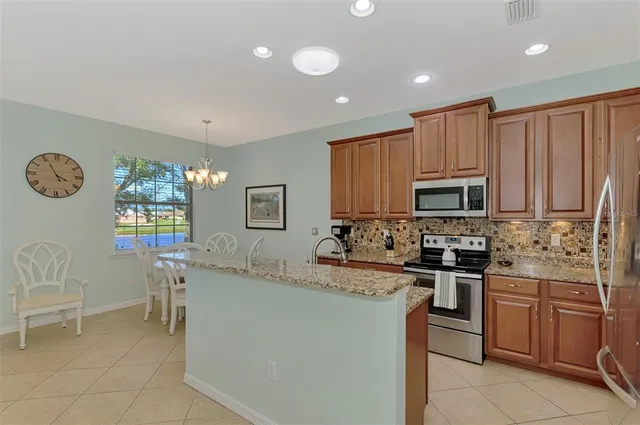 a view of a dining room with furniture and a chandelier