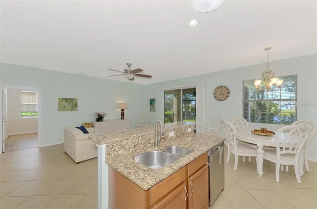 a kitchen with stainless steel appliances a table chairs and chandelier