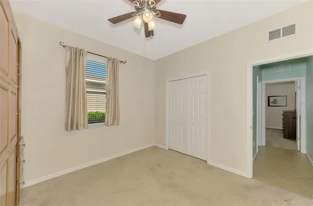 a bedroom with two beds and a chandelier