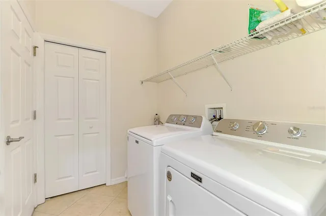 a view of a house with pool and sitting area