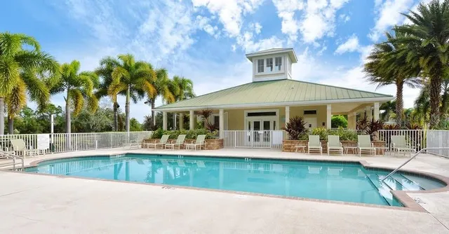 a house with green field in front of it
