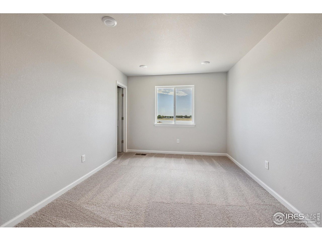 882 Mesic Lane Windsor, CO 80550 - Photo 12 of 26 an empty room with a empty space and windows