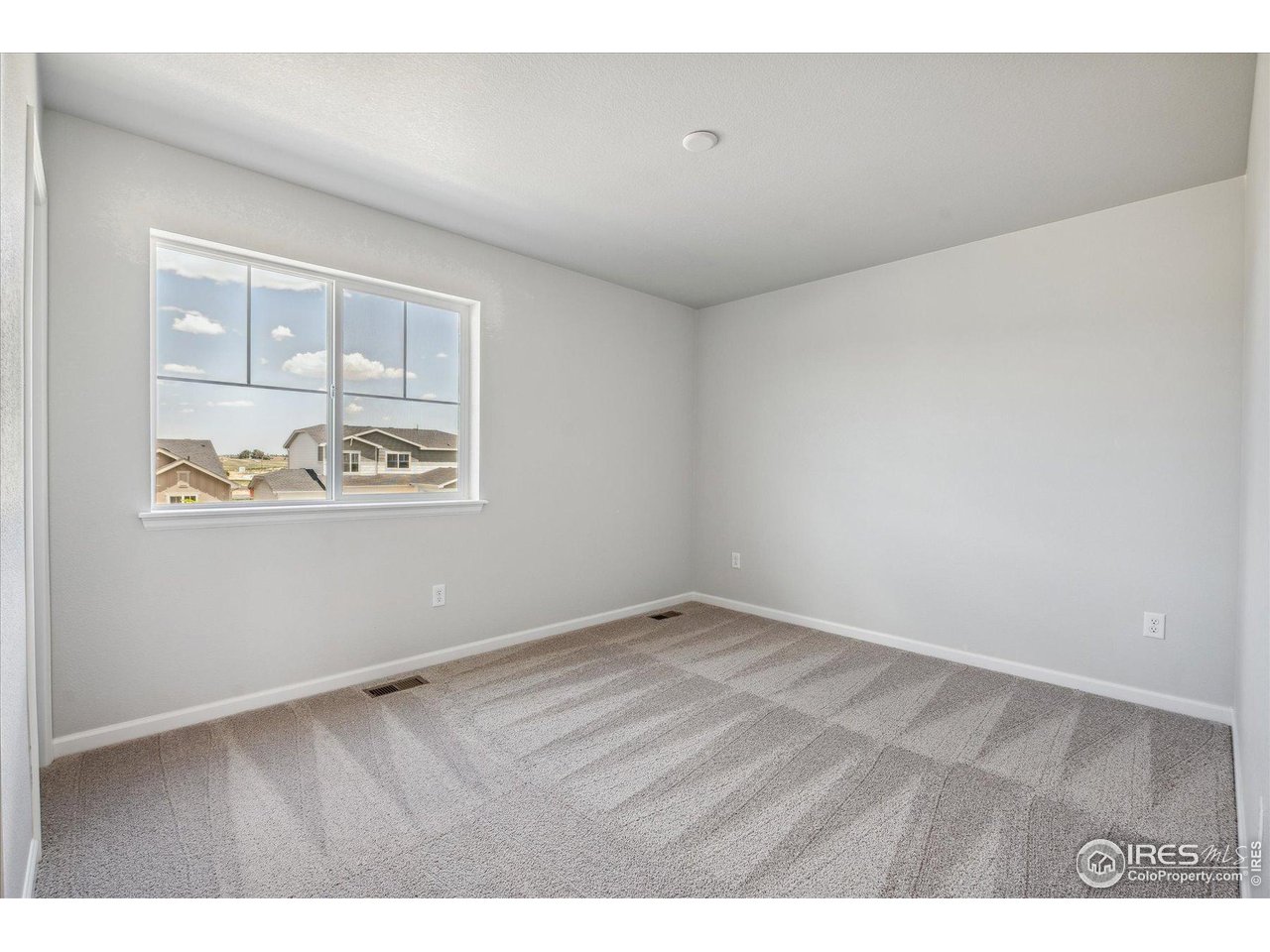882 Mesic Lane Windsor, CO 80550 - Photo 14 of 26 a view of an empty room with a window