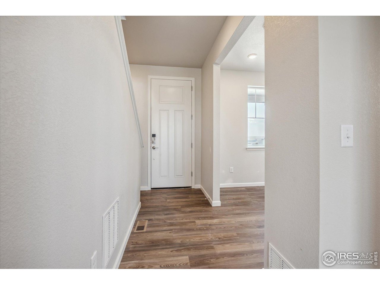882 Mesic Lane Windsor, CO 80550 - Photo 3 of 26 a view of an empty room with wooden floor