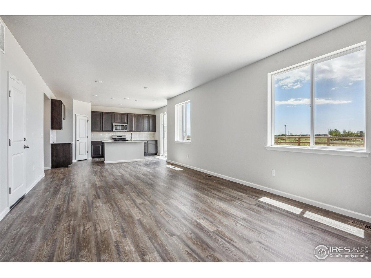 882 Mesic Lane Windsor, CO 80550 - Photo 8 of 26 a view of kitchen and wooden floor