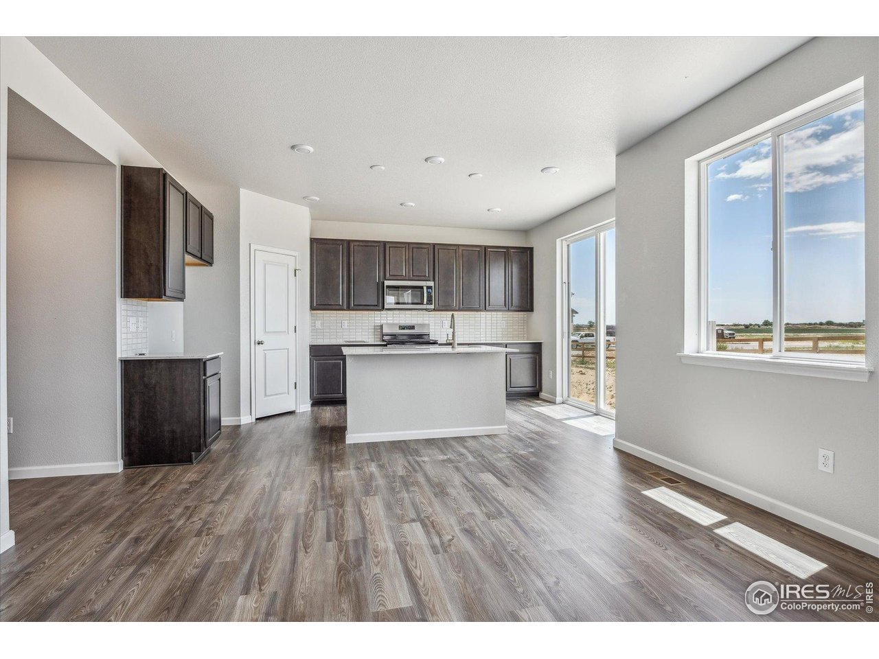 882 Mesic Lane Windsor, CO 80550 - Photo 9 of 26 a view of kitchen with wooden floor