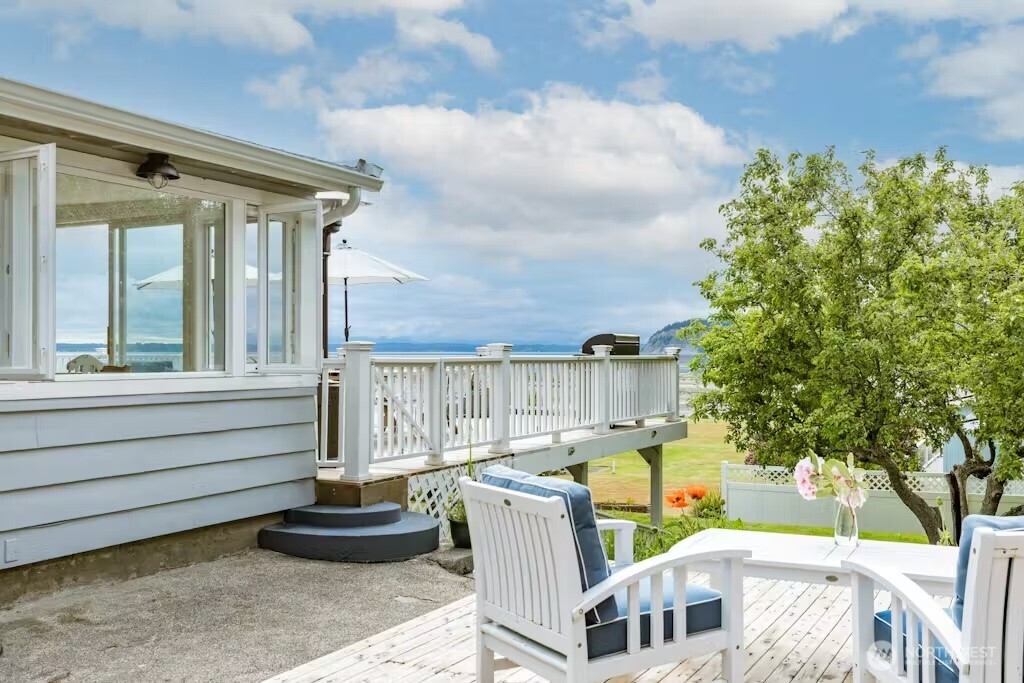 a view of a patio with table and chairs and potted plants