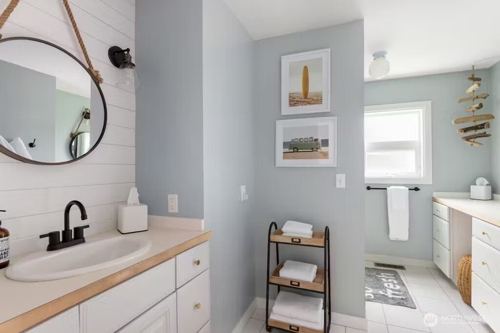 6192 Kohlwes Road Clinton, WA 98236 - Photo 12 of 12 a bathroom with a sink mirror and vanity