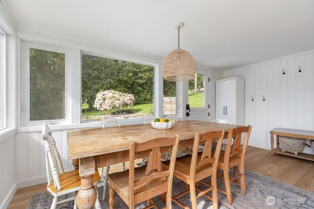 6192 Kohlwes Road Clinton, WA 98236 - Photo 2 of 12 a view of a dining room with furniture window and wooden floor