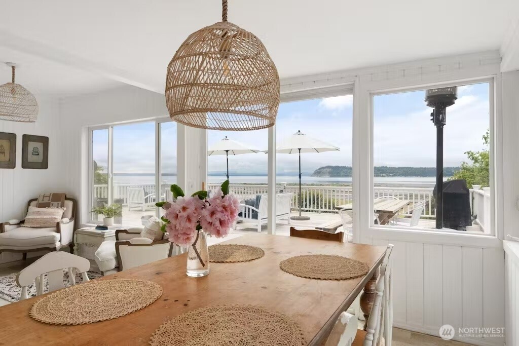 6192 Kohlwes Road Clinton, WA 98236 - Photo 3 of 12 a room with furniture a window and a chandelier