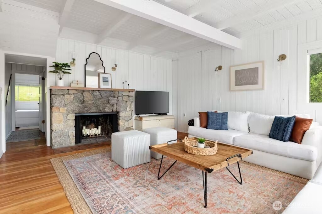 6192 Kohlwes Road Clinton, WA 98236 - Photo 9 of 12 a living room with furniture and a fireplace