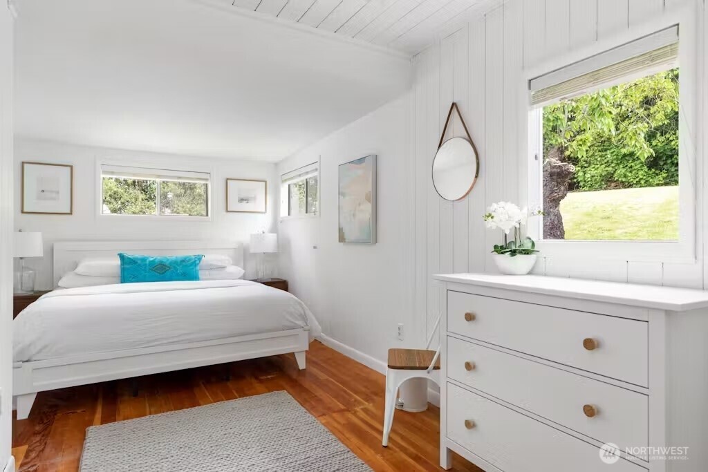 6192 Kohlwes Road Clinton, WA 98236 - Photo 10 of 12 a bedroom with a large bed and a dresser