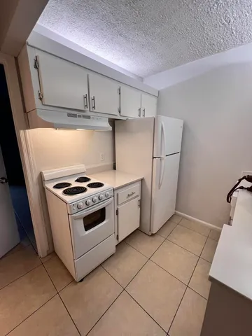 a kitchen with a sink a stove and cabinets