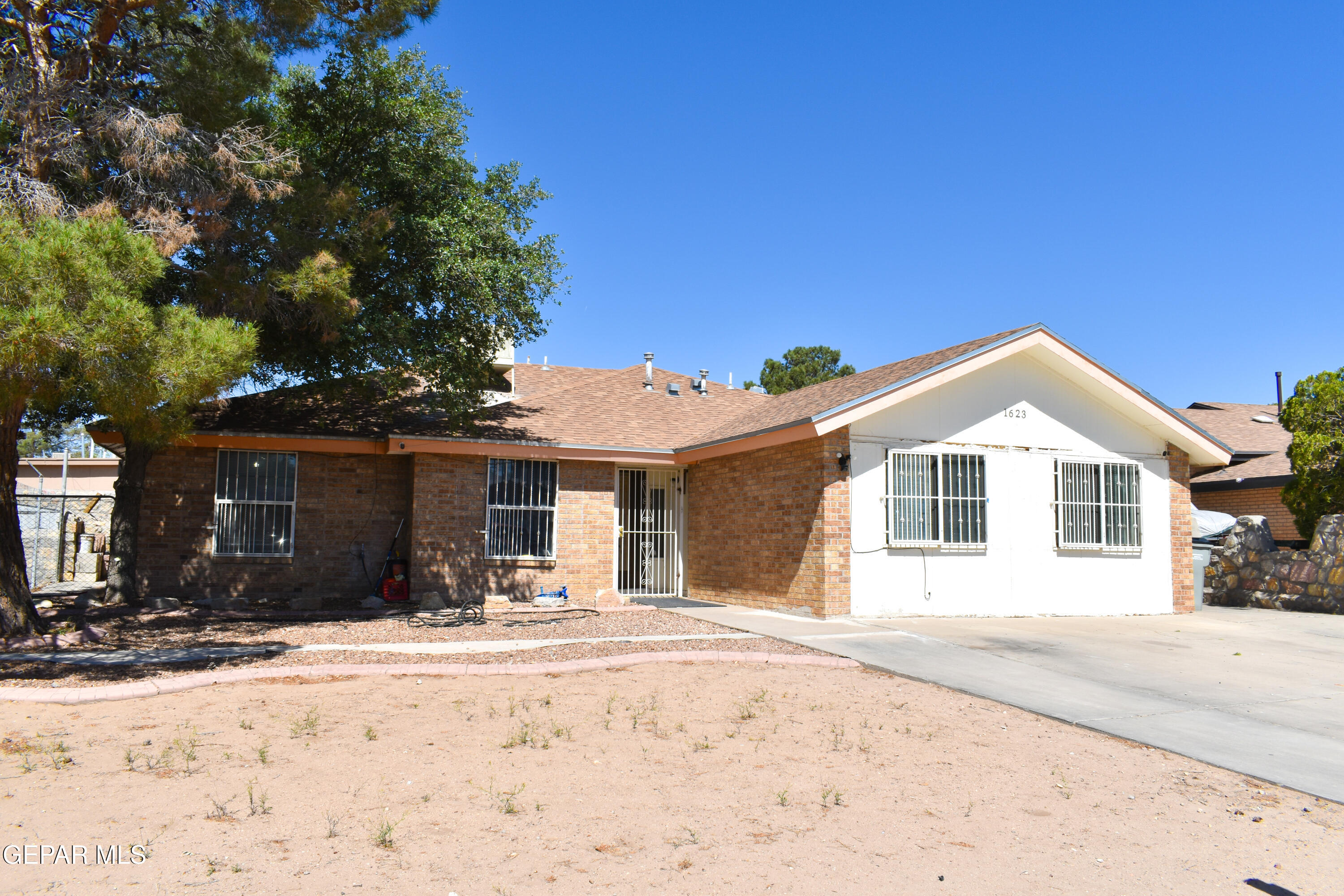 1623 Brian Ray Circle El Paso, TX 79936 - Photo 3 of 41 a front view of a house with a yard covered in snow