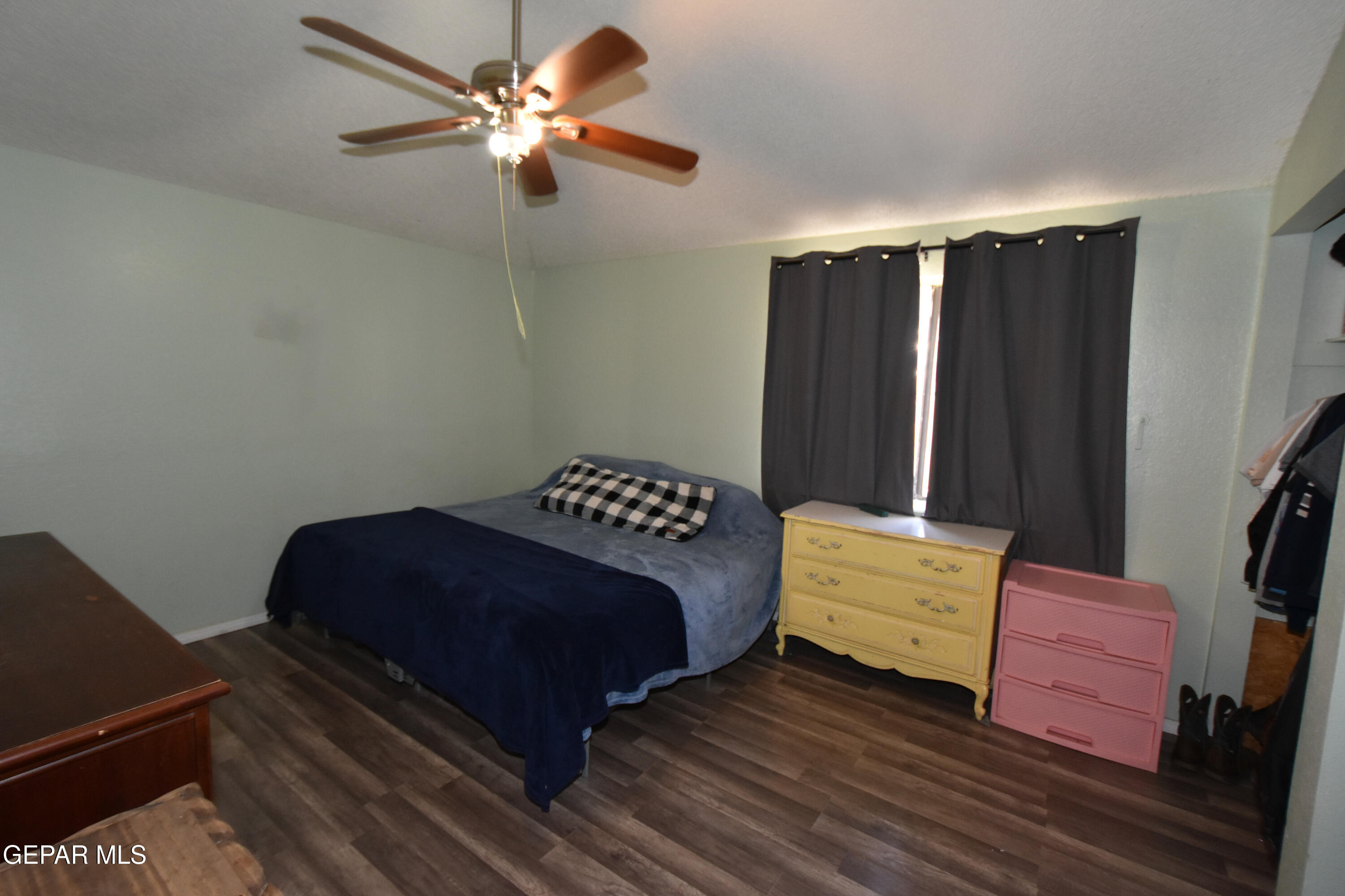 1623 Brian Ray Circle El Paso, TX 79936 - Photo 32 of 41 a bedroom with a bed and a chandelier