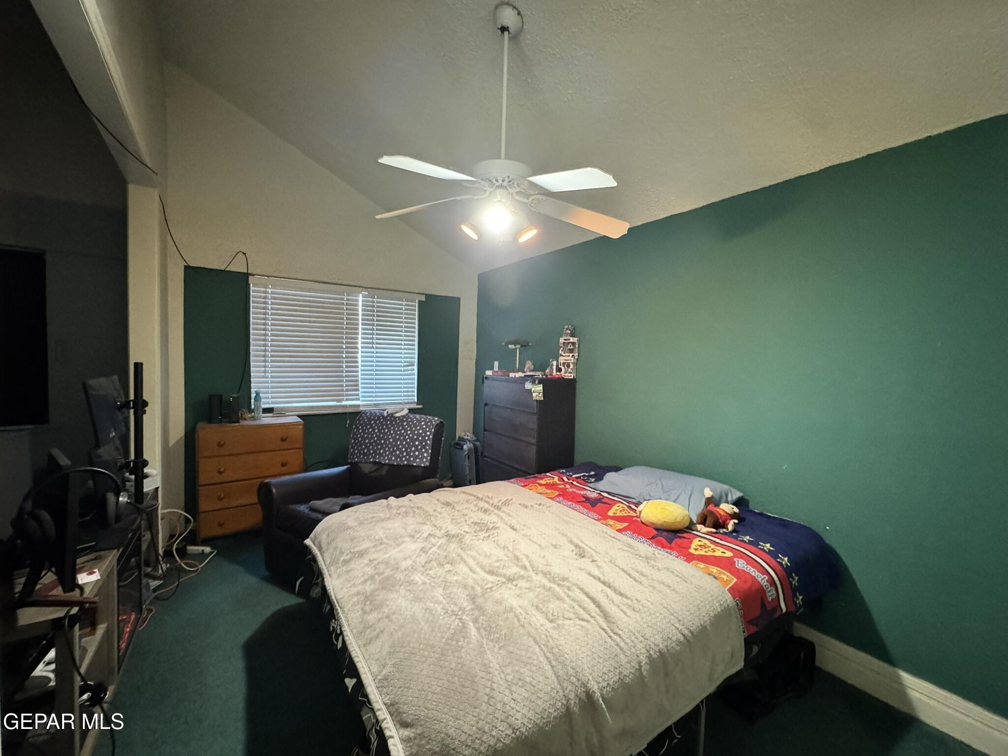 1623 Brian Ray Circle El Paso, TX 79936 - Photo 5 of 37 a bedroom with a bed chandelier and a window