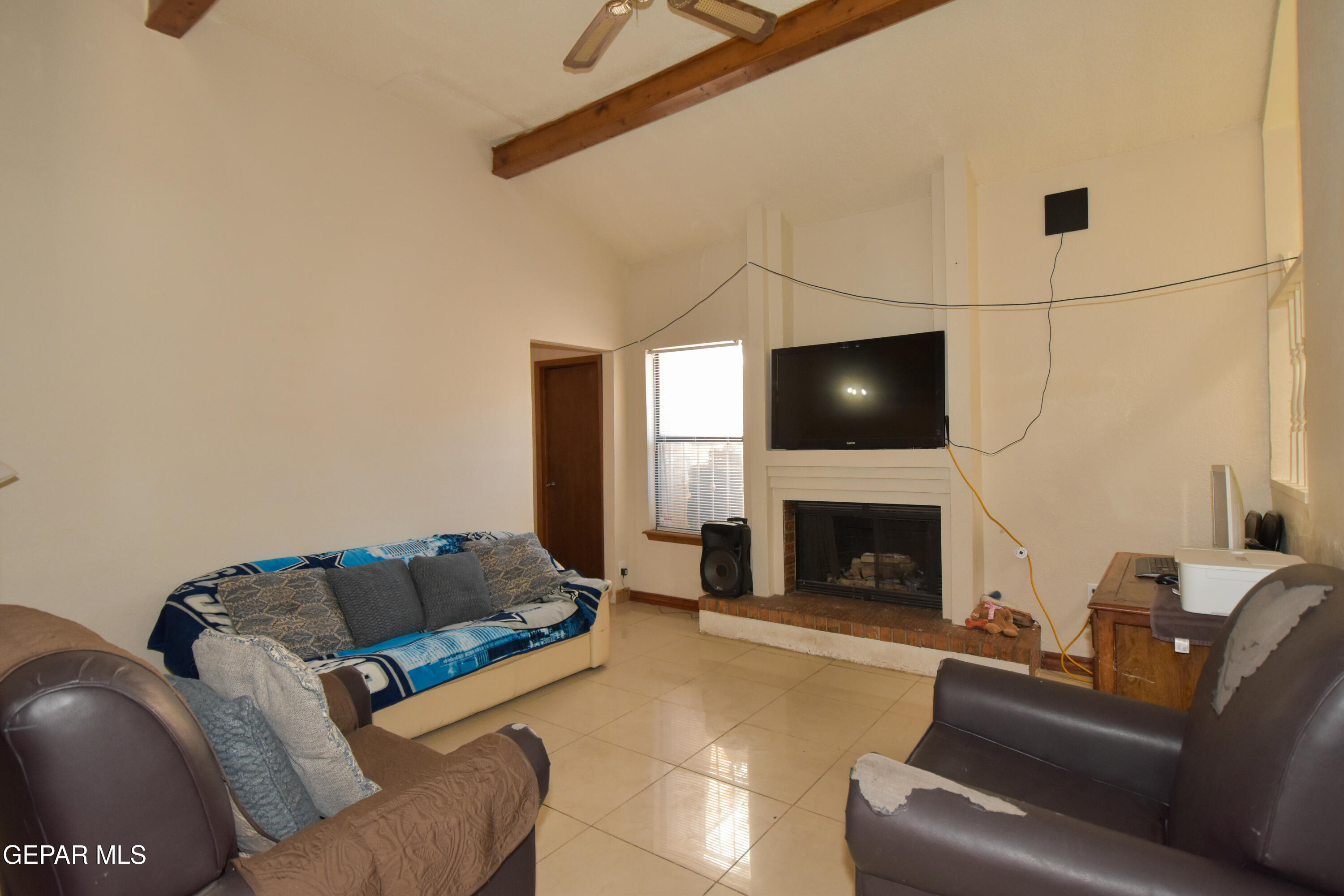 1623 Brian Ray Circle El Paso, TX 79936 - Photo 7 of 41 a living room with furniture a fireplace and a flat screen tv