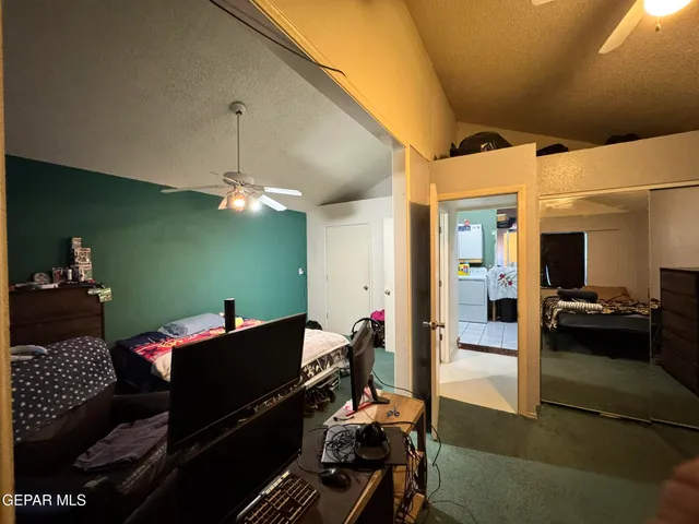 a bedroom with furniture and a chandelier