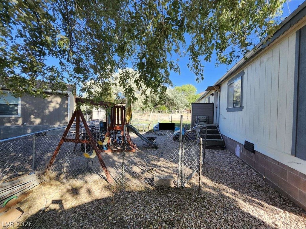 942 Holt Caliente, NV 89008 - Photo 3 of 22 A fully fenced backyard offers a secure and playful environment for all.