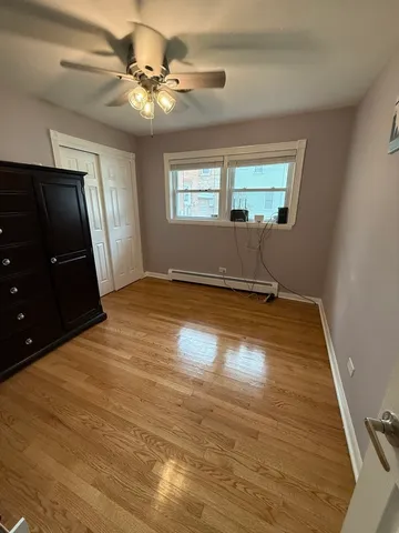 a view of a livingroom with a ceiling fan and window