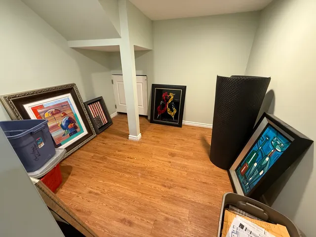 a view of a living room with furniture and wooden floor