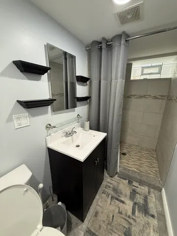 a bathroom with a sink toilet and shower