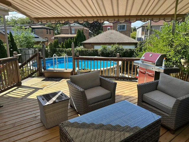 a patio with patio a table and chairs under an umbrella