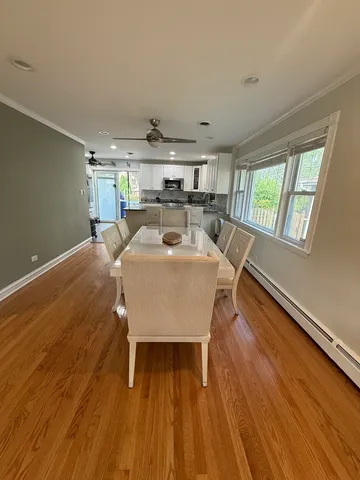 a view of a dining room with furniture window and wooden floor