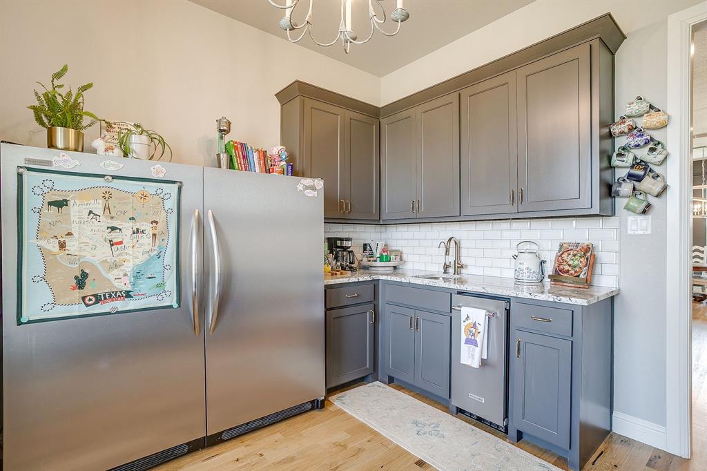 116 Aviara Ridge Road Poolville, TX 76487 - Photo 26 of 38 a kitchen with stainless steel appliances granite countertop a refrigerator a stove and a sink